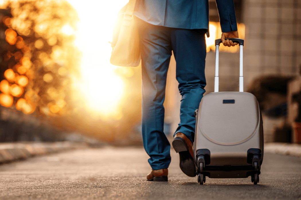 Traveler walking through an airport with a suitcase