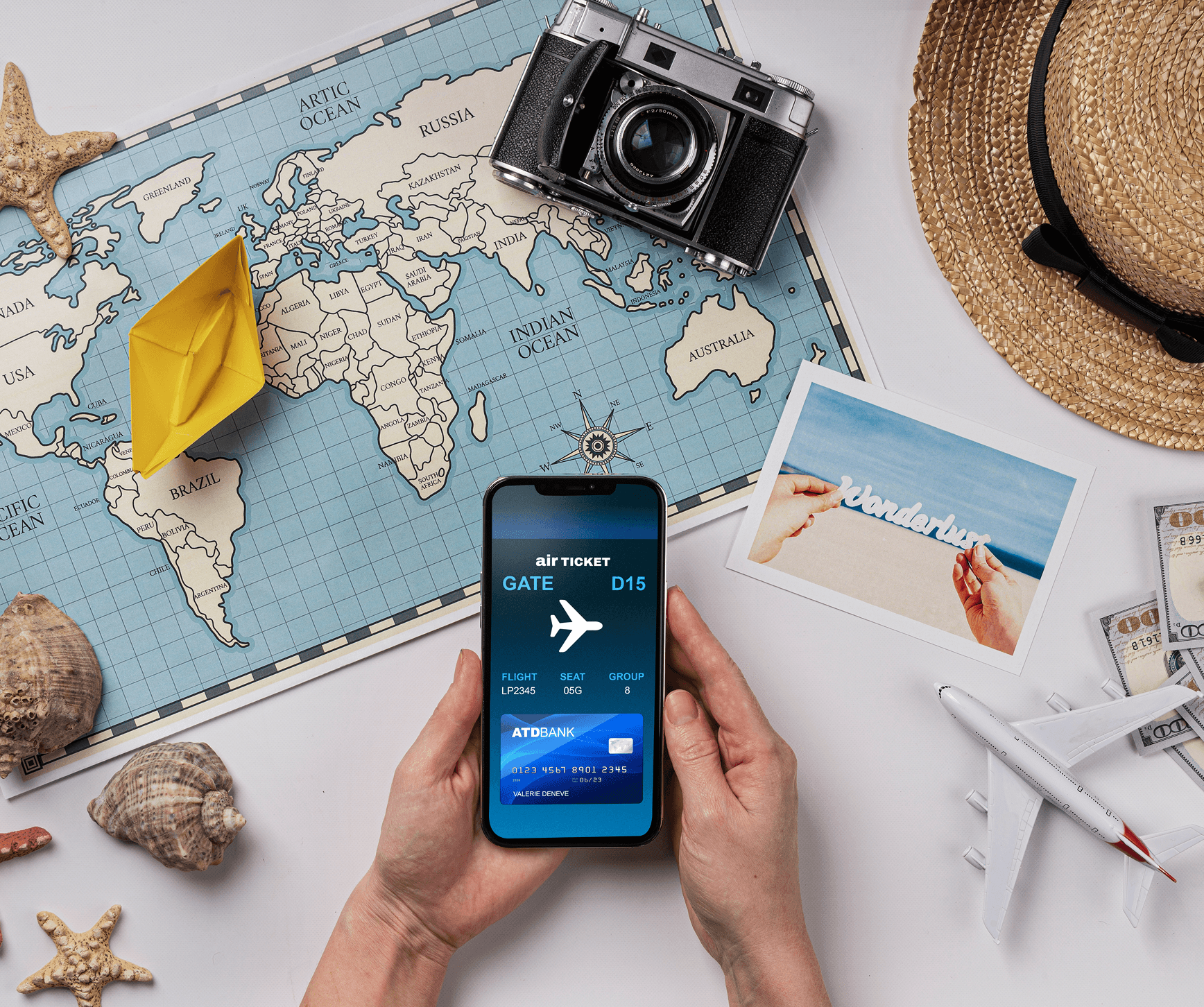 Travel essentials laid out with a boarding pass on a smartphone